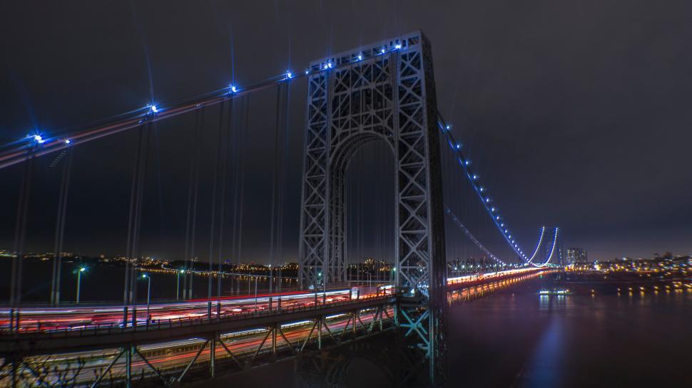 Free Image of Illuminated Bridge Spanning River at Night 
