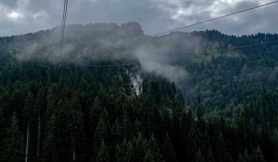 Free Image of Ski Lift Ascending a Fog-Covered Mountain 