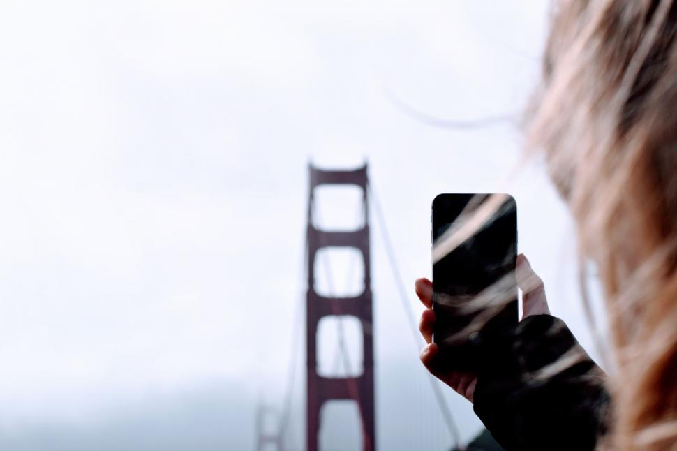 Free Image of Woman Taking Picture of Golden Gate Bridge 