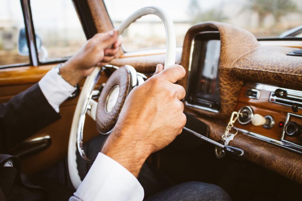 Free Image of Man Driving Car With Steering Wheel 