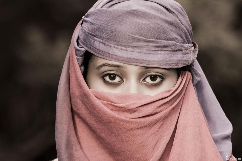 Free Image of Woman Wearing Headscarf and Scarf Over Her Head 