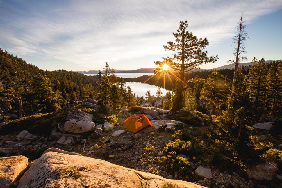 Free Image of Tent Set Up on Rocky Cliff Overlooking Lake 