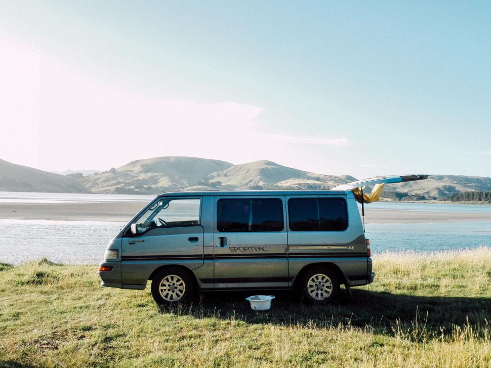 Free Image of Van Parked Next to Water Body in Field 