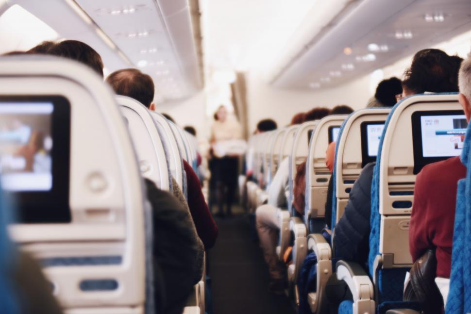 Free Image of Group of People Sitting on Seats in an Airplane 