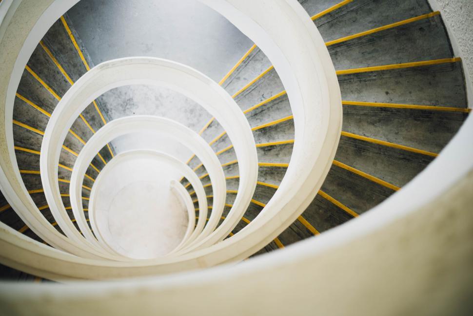 Free Image of Spiral Staircase With Yellow Railings in Building 