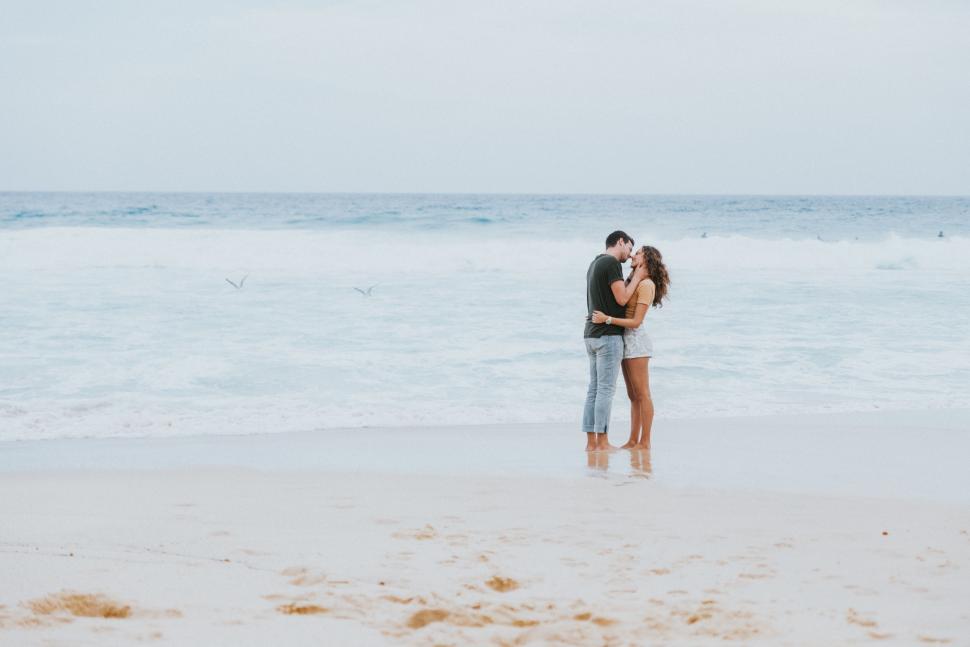 Free Image of Couple Standing in the Sand 