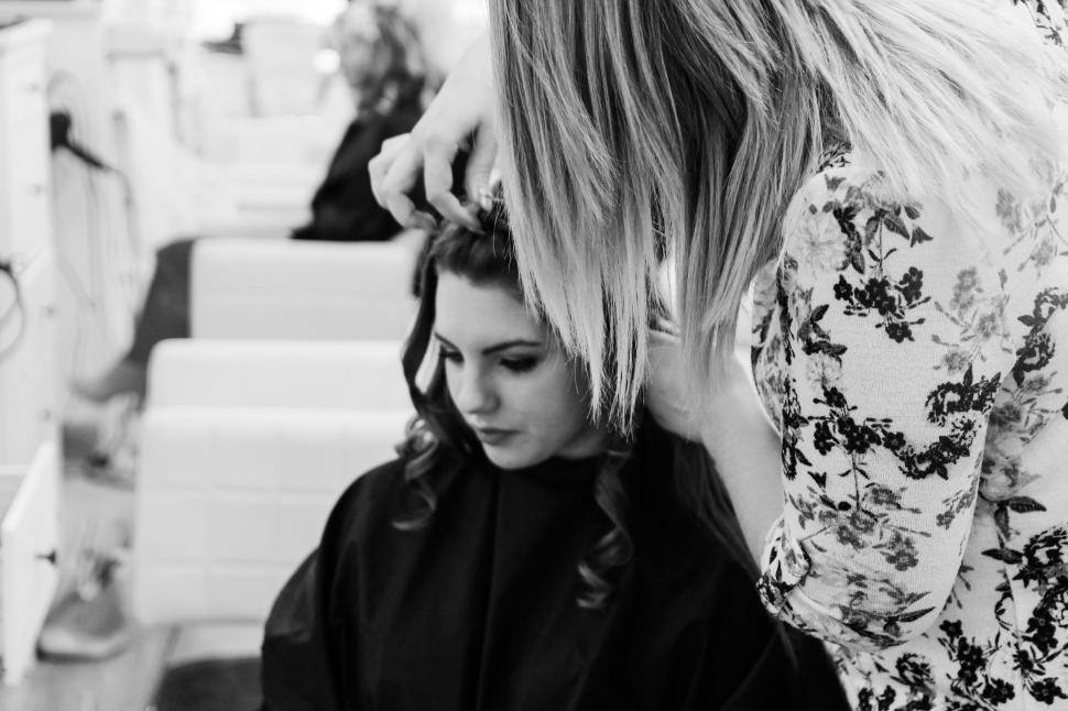 Free Image of Woman Getting Hair Styled by Another Woman 