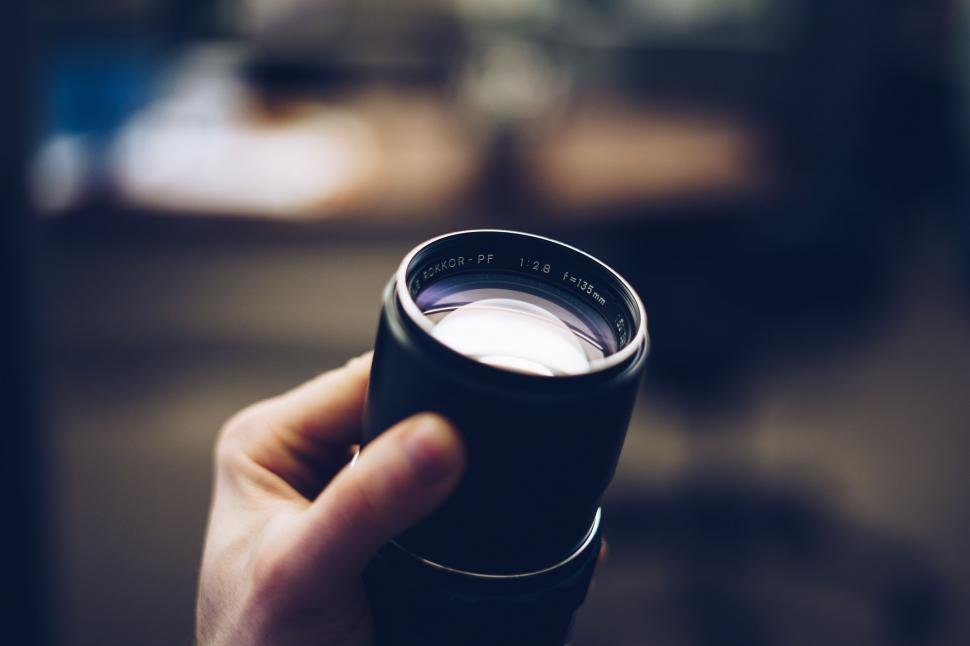 Free Image of Person Holding Camera Lens 