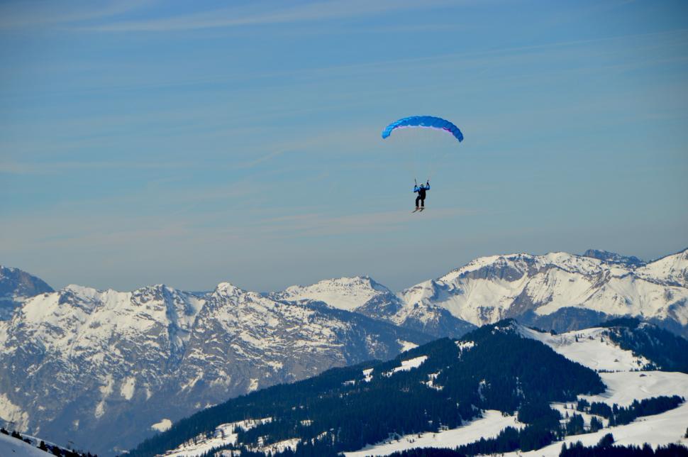 Free Image of Paragliding Over Snowy Mountain Range 
