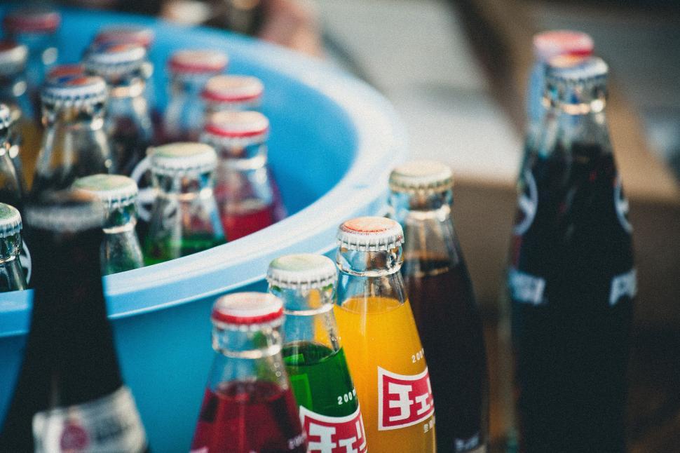 Free Image of Blue Bucket Filled With Bottles of Soda 