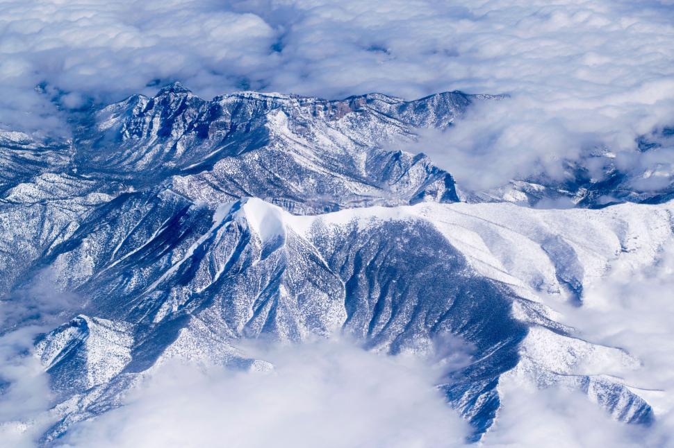 Free Image of A Glimpse of a Mountain Range From an Airplane 