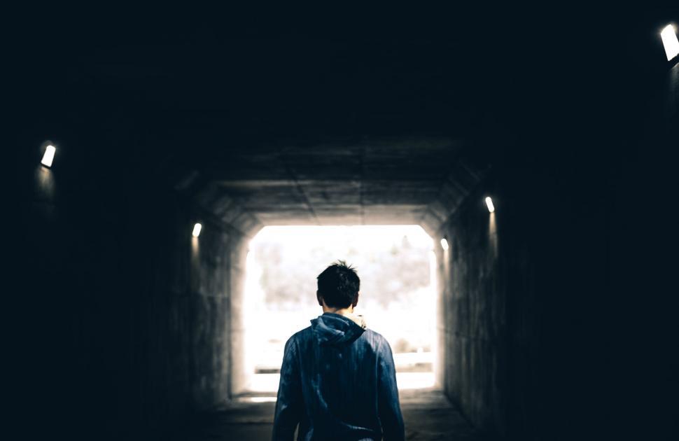 Free Image of Man Standing in Dark Tunnel 