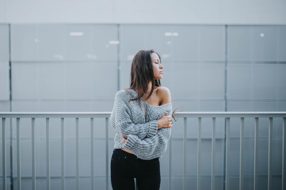 Free Image of Woman Standing in Front of Wall With Arms Crossed 