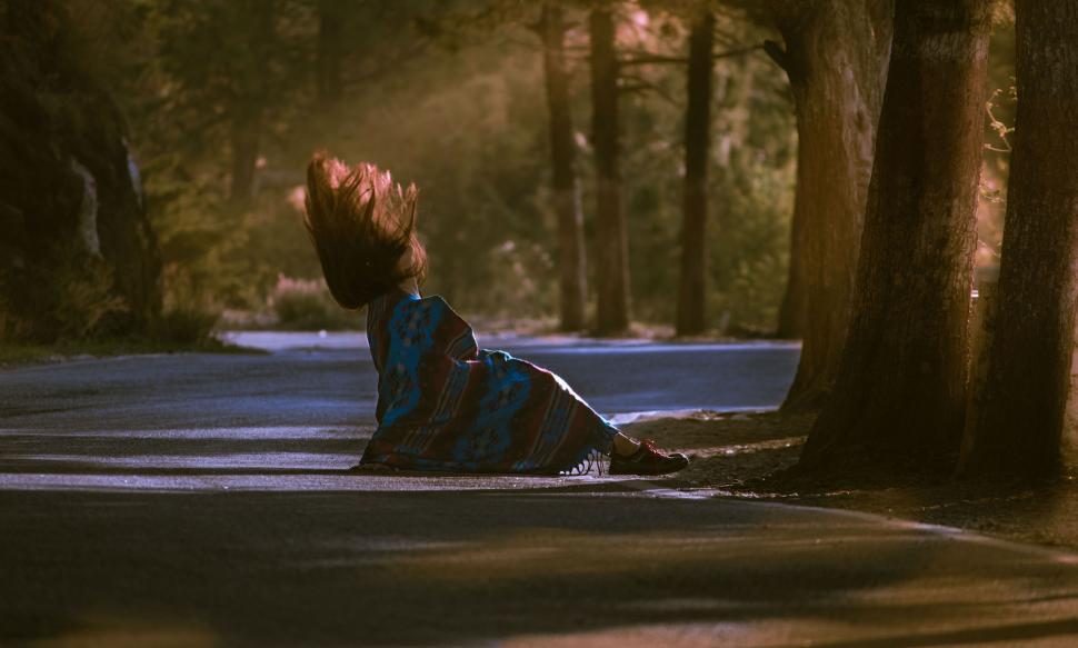Free Image of Person Laying on Ground in Middle of Road 