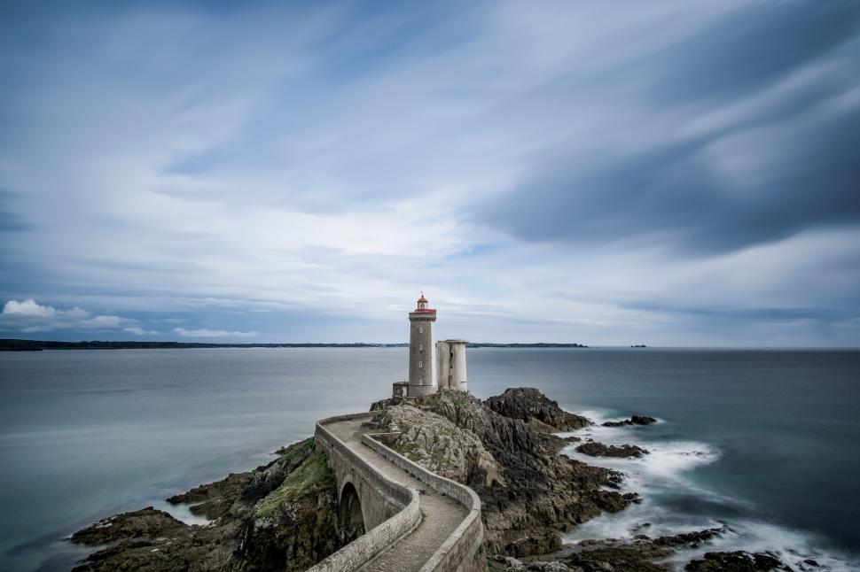 Free Image of Lighthouse Perched on Cliff by Ocean 