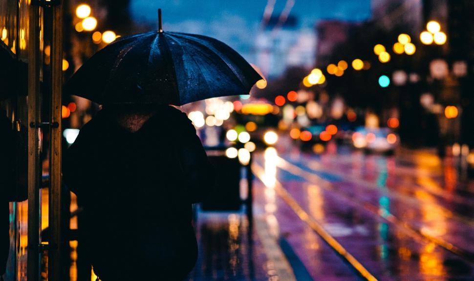 Free Image of Person Holding Umbrella on Rainy Night 
