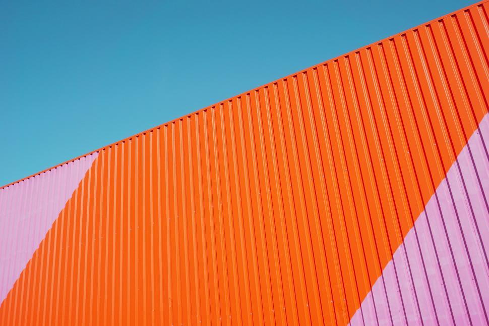 Free Image of Orange and Pink Wall With Blue Sky 