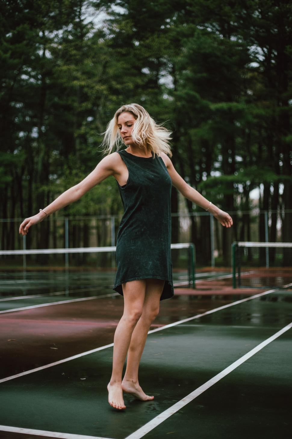 Free Image of Woman Standing on Tennis Court 