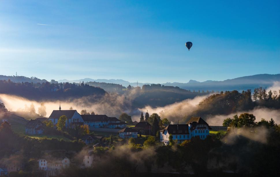 Free Image of Hot Air Balloon Flying Over Town 