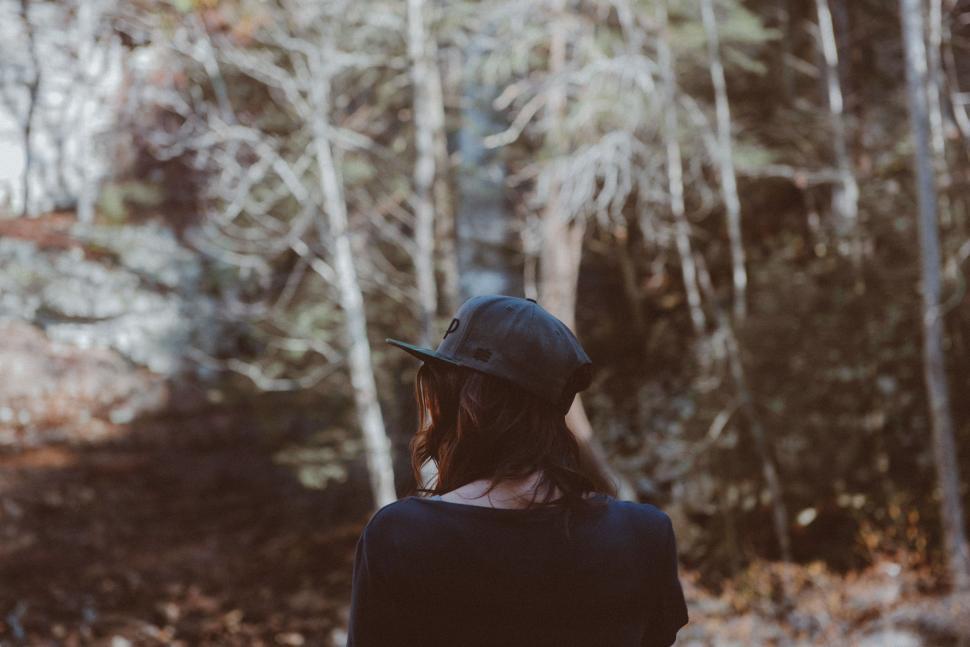 Free Image of Woman in Hat Standing in Woods 