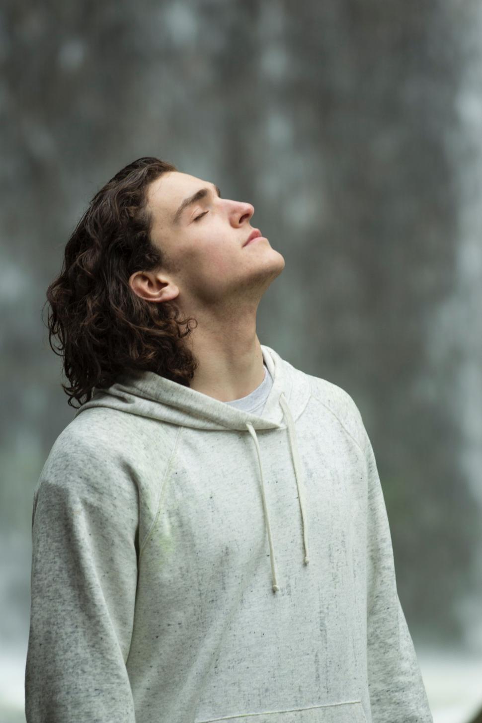 Free Image of Man in a Hoodie Looking Up Into the Sky 