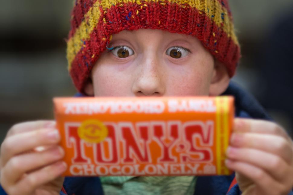 Free Image of Young Boy Holding Up a Box of Food 