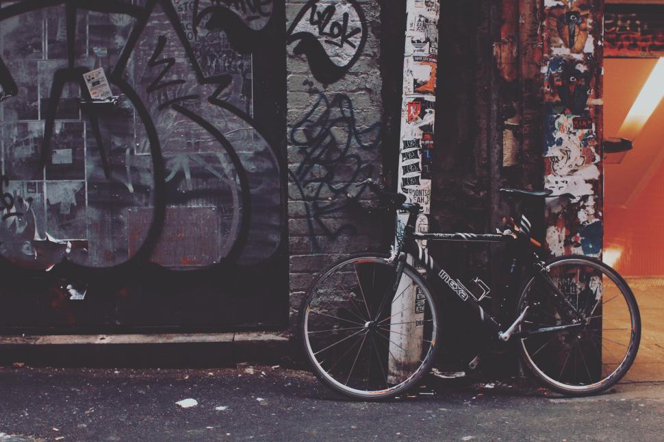 Free Image of Bike Parked Next to Graffiti-Covered Wall 
