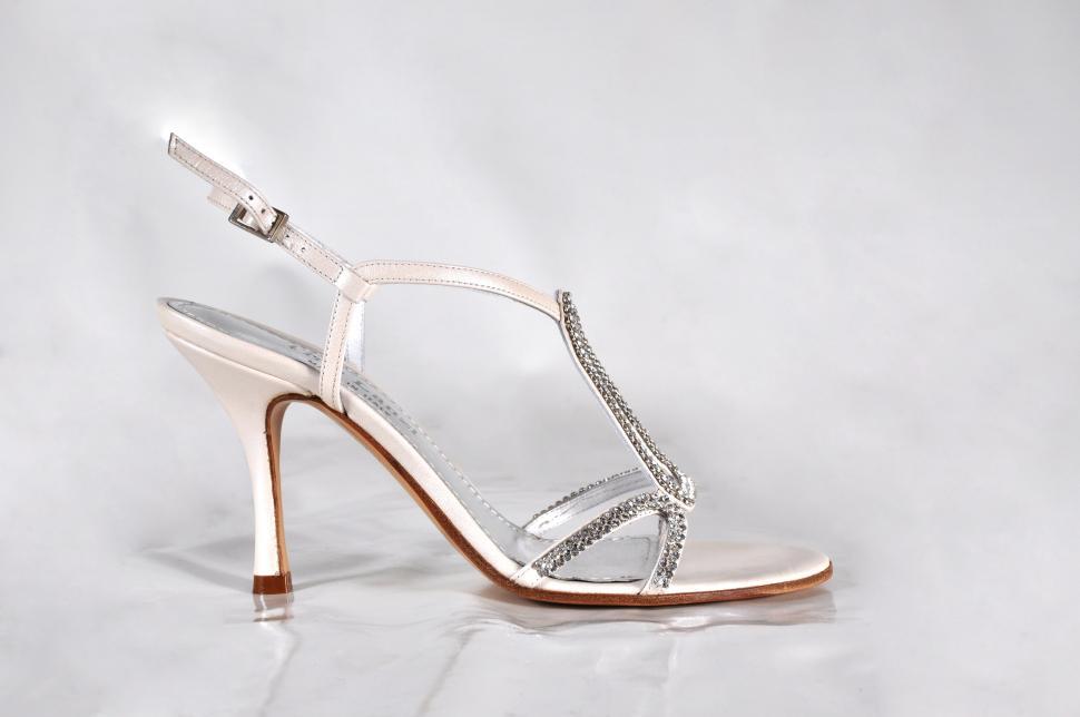 Free Image of White High Heeled Shoes on White Surface 