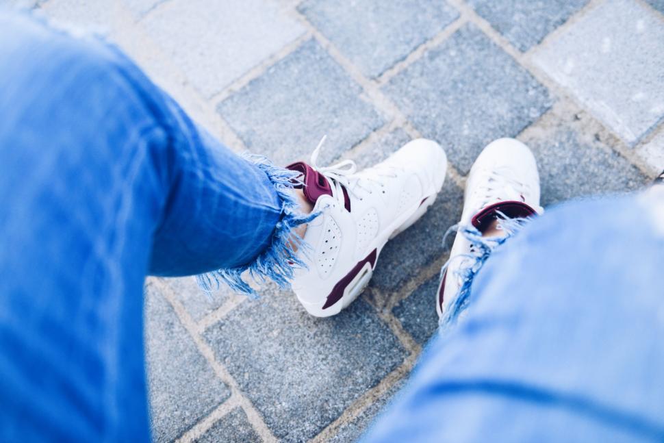 Free Image of Feet in Jeans and Sneakers 