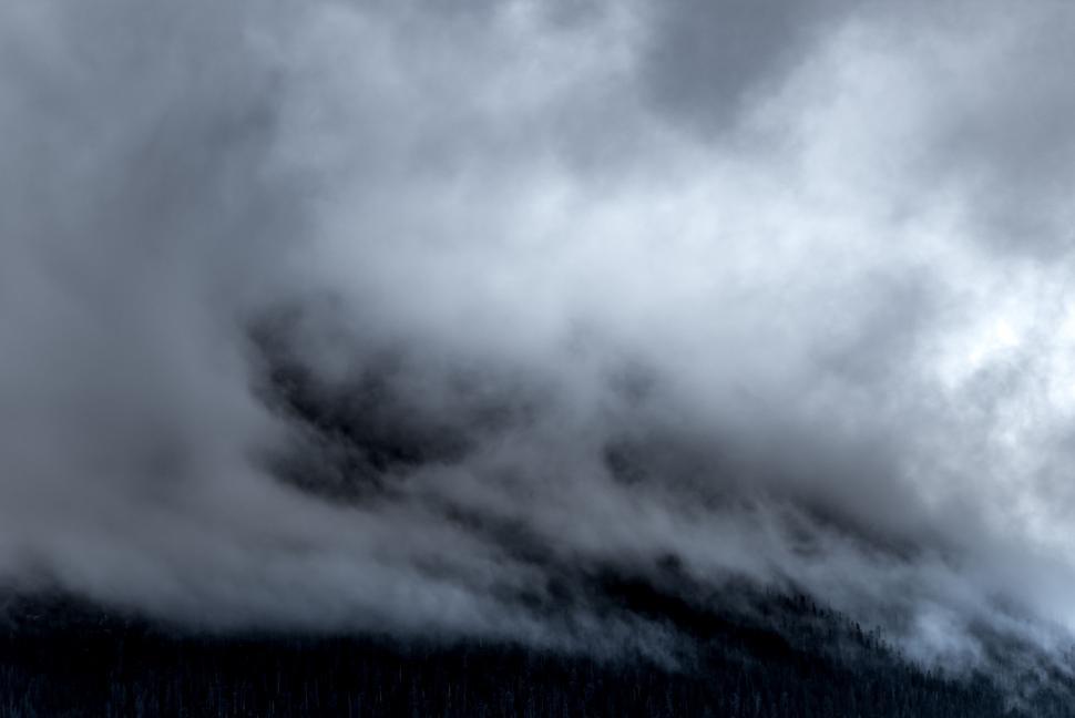 Free Image of Clouds Blanketing a Mountain Peak 
