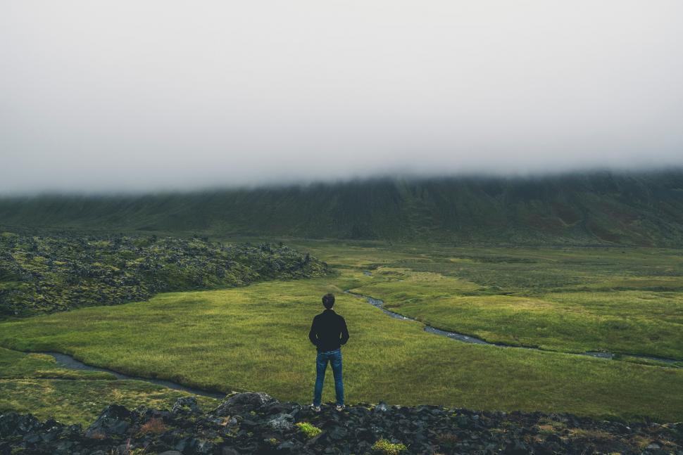Free Image of Man Standing on Lush Green Field 