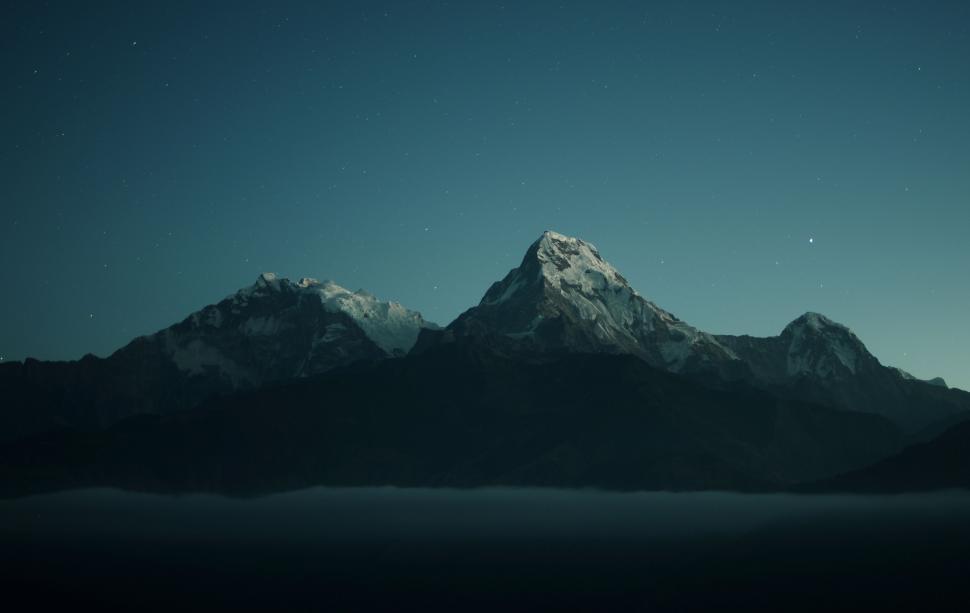 Free Image of Snow-Covered Mountain Range at Night 