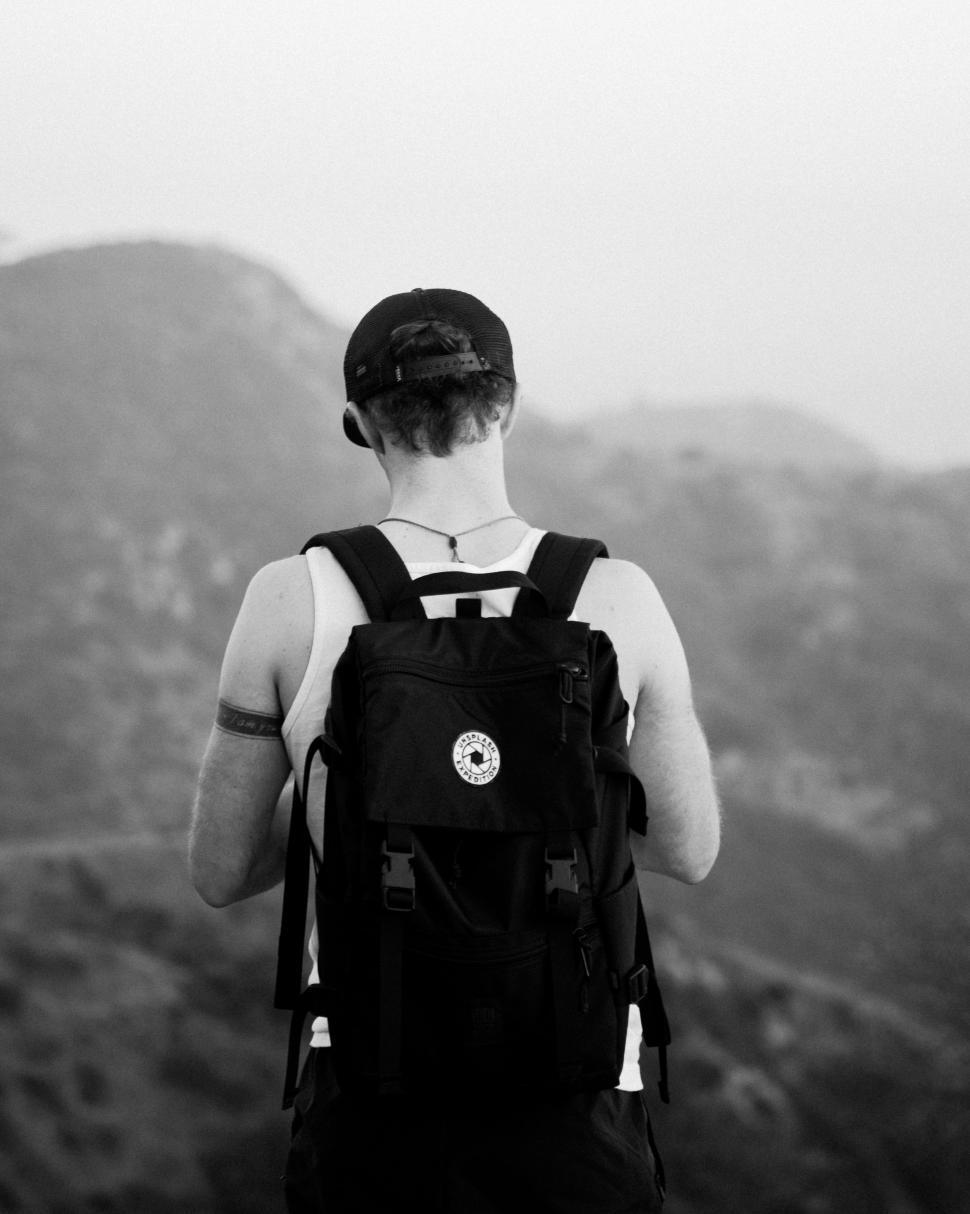 Free Image of Person With Backpack Looking at Mountains 