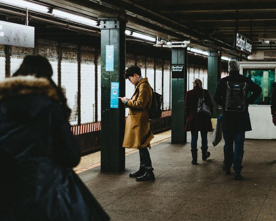 Free Image of Group of People Walking on Subway Platform 