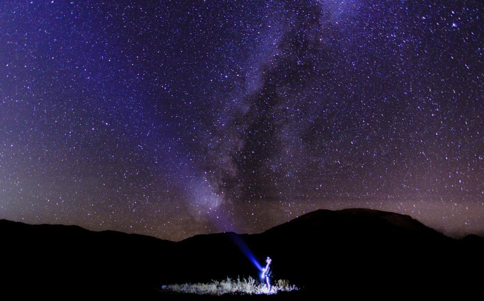 Free Image of Person Standing in Field Under Star-Filled Night Sky 