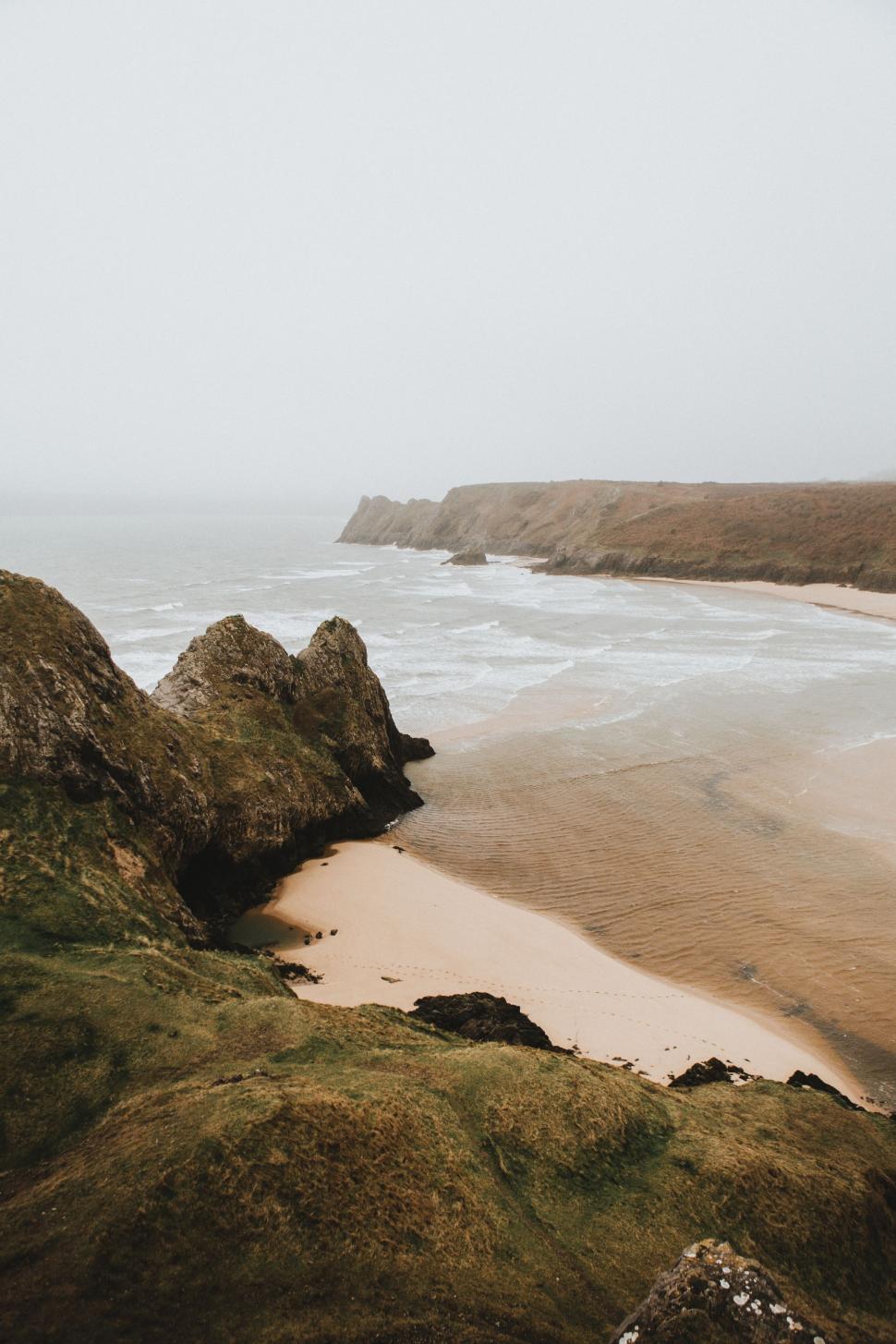 Free Image of Foggy Day at a Sandy Beach by the Ocean 