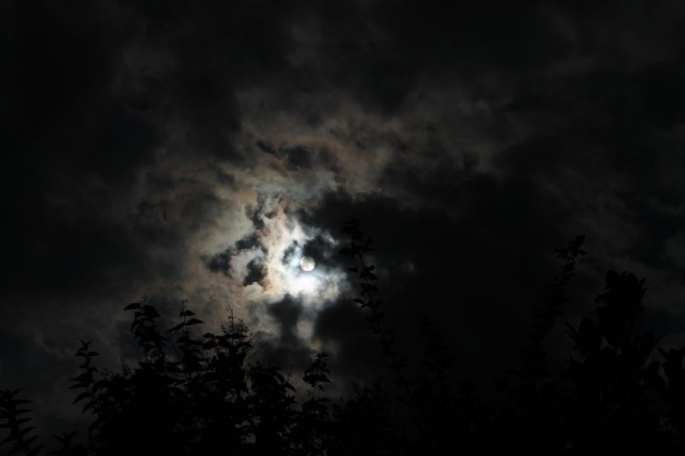 Free Image of Full Moon Emerging Through Dark Clouds 