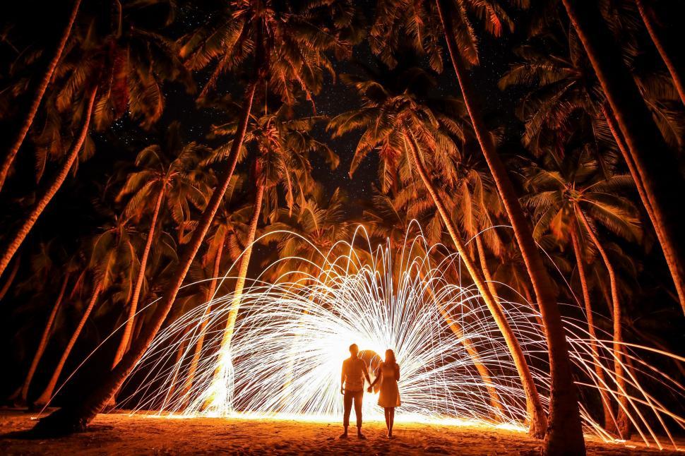 Free Image of Two People Standing in Front of Firework Display 