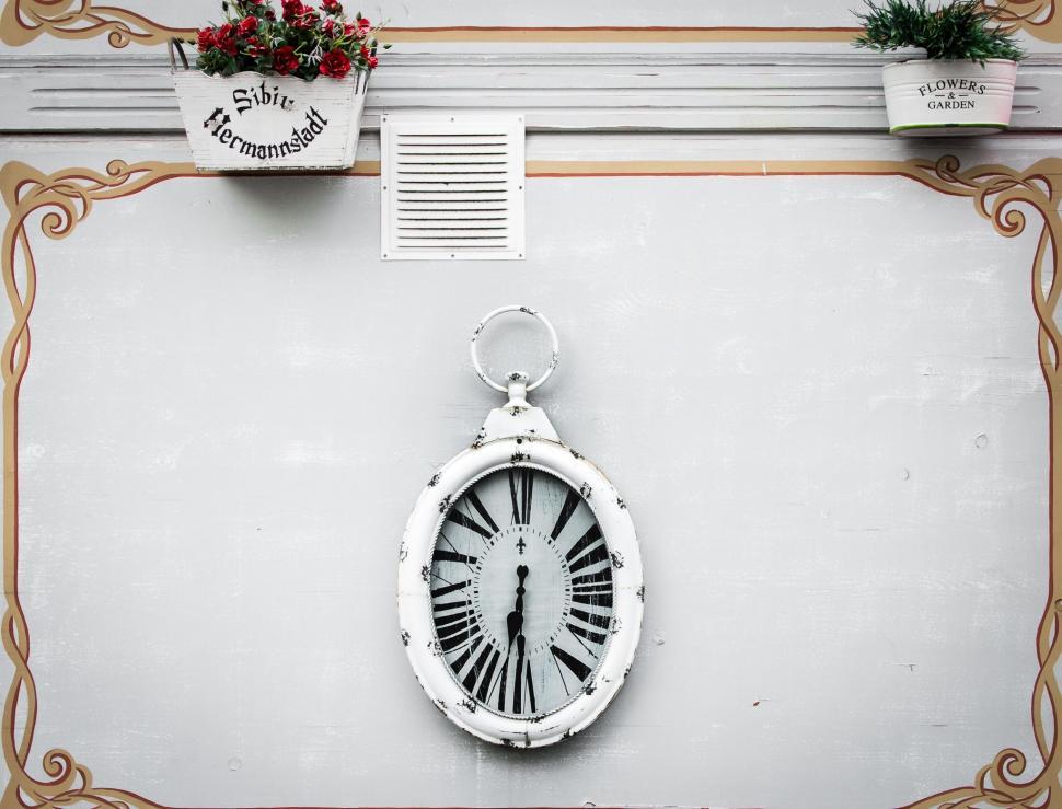 Free Image of Clock Hanging on Side of Building 