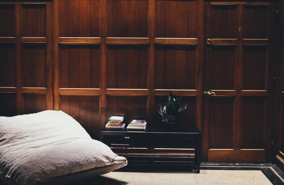 Free Image of Bed Next to Bookshelf in Bedroom 