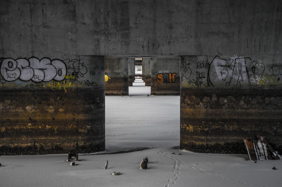 Free Image of Graffiti-Covered Bridge Over Snowy Ground 