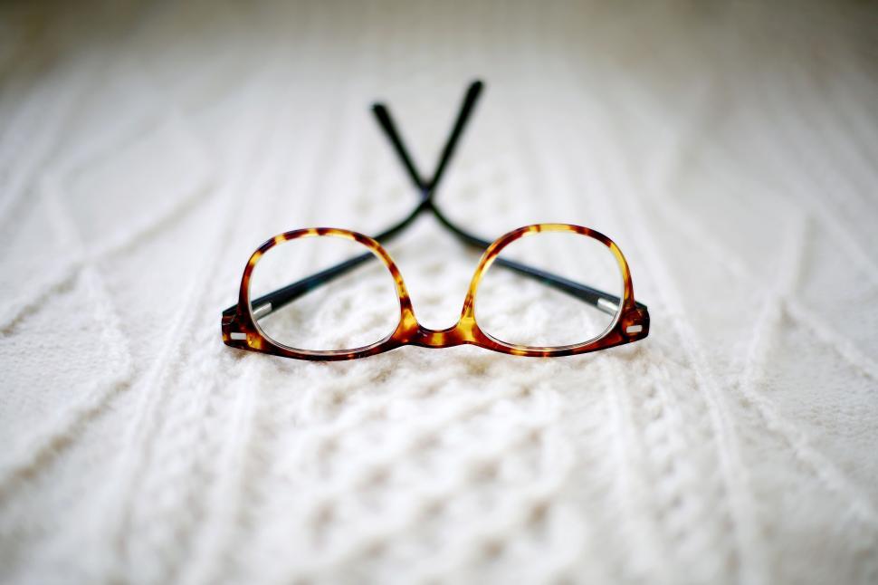Free Image of Glasses Resting on Bed 
