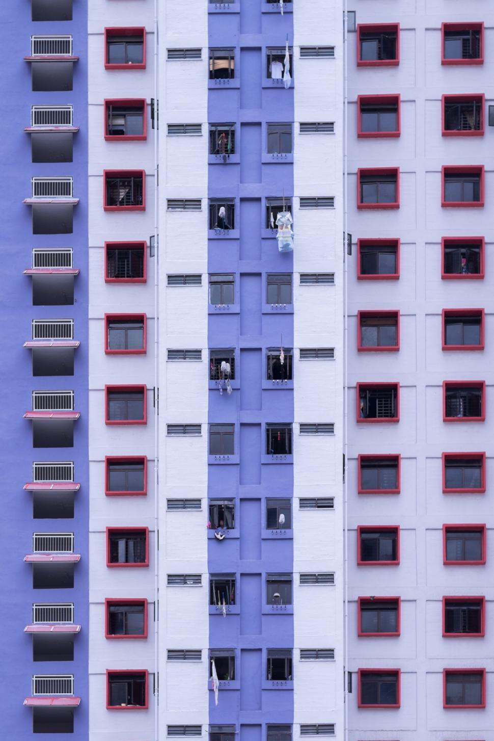 Free Image of Tall White and Blue Building With Lots of Windows 
