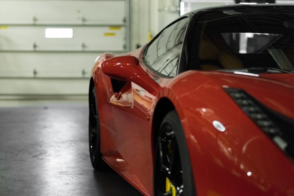 Free Image of Red Sports Car Parked in Garage 