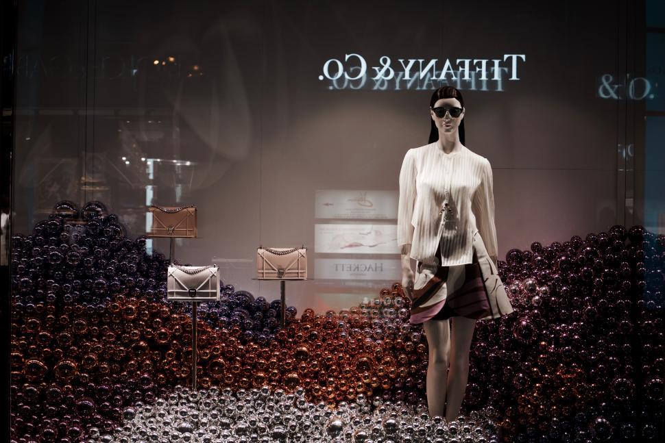 Free Image of Woman Walking Down a Runway in Front of Display 