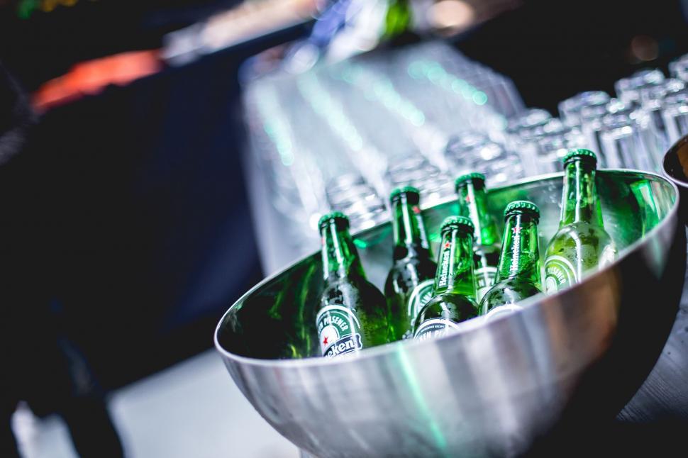 Free Image of Metal Bowl Filled With Bottles of Beer 