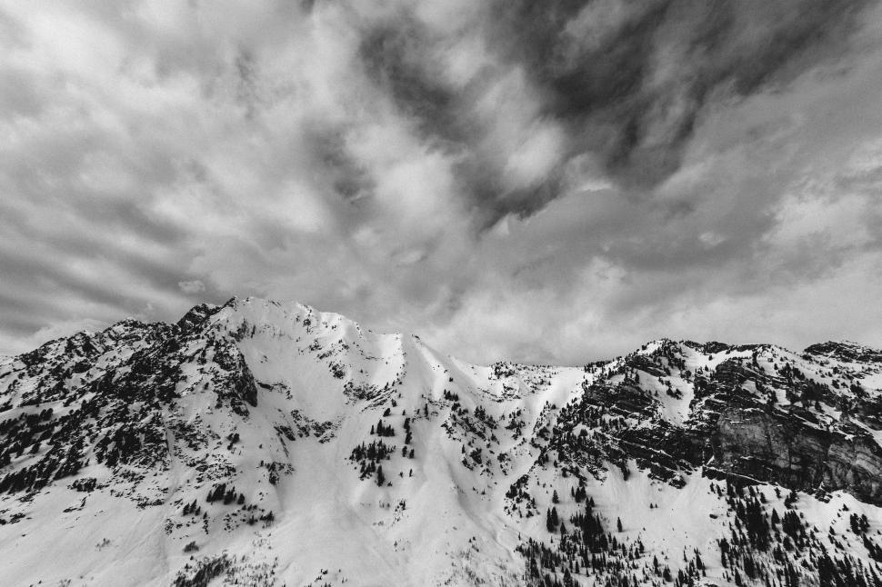 Free Image of Snow-Covered Mountain Under Cloudy Sky 