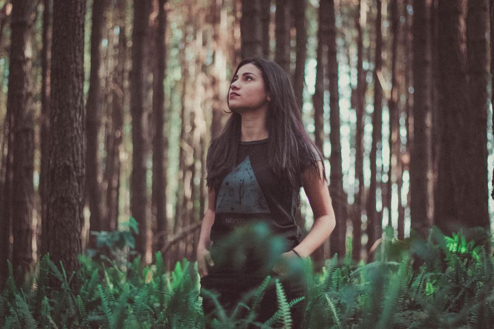 Free Image of Woman Standing in the Middle of a Forest 