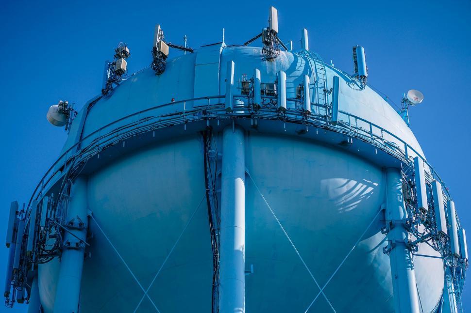 Free Image of Large Blue Water Tank Under Blue Sky 