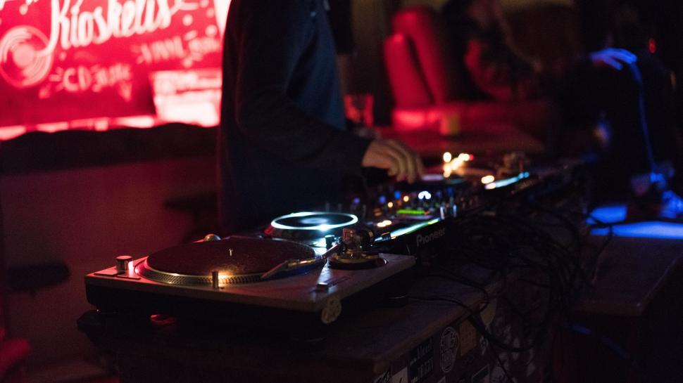 Free Image of A DJ Mixing Music in a Dark Room 